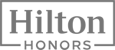 The image shows the logo of Hilton Honors, featuring the name "Hilton" above the word "HONORS" in a rectangular frame.