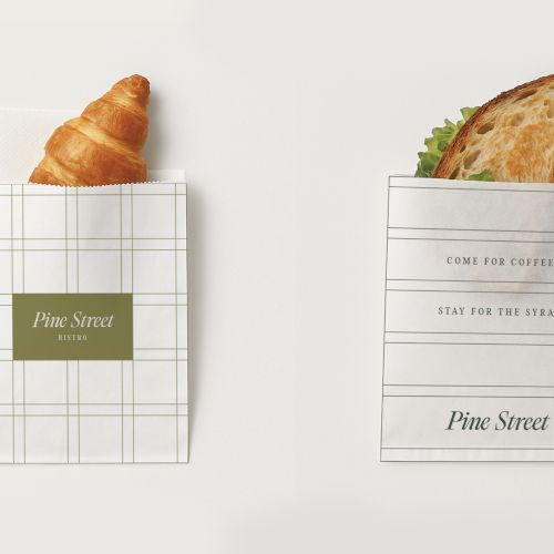 Two paper bags contain a croissant and a sandwich, with "Pine Street" branding and the text "COME FOR COFFEE STAY FOR THE SPIRITS."